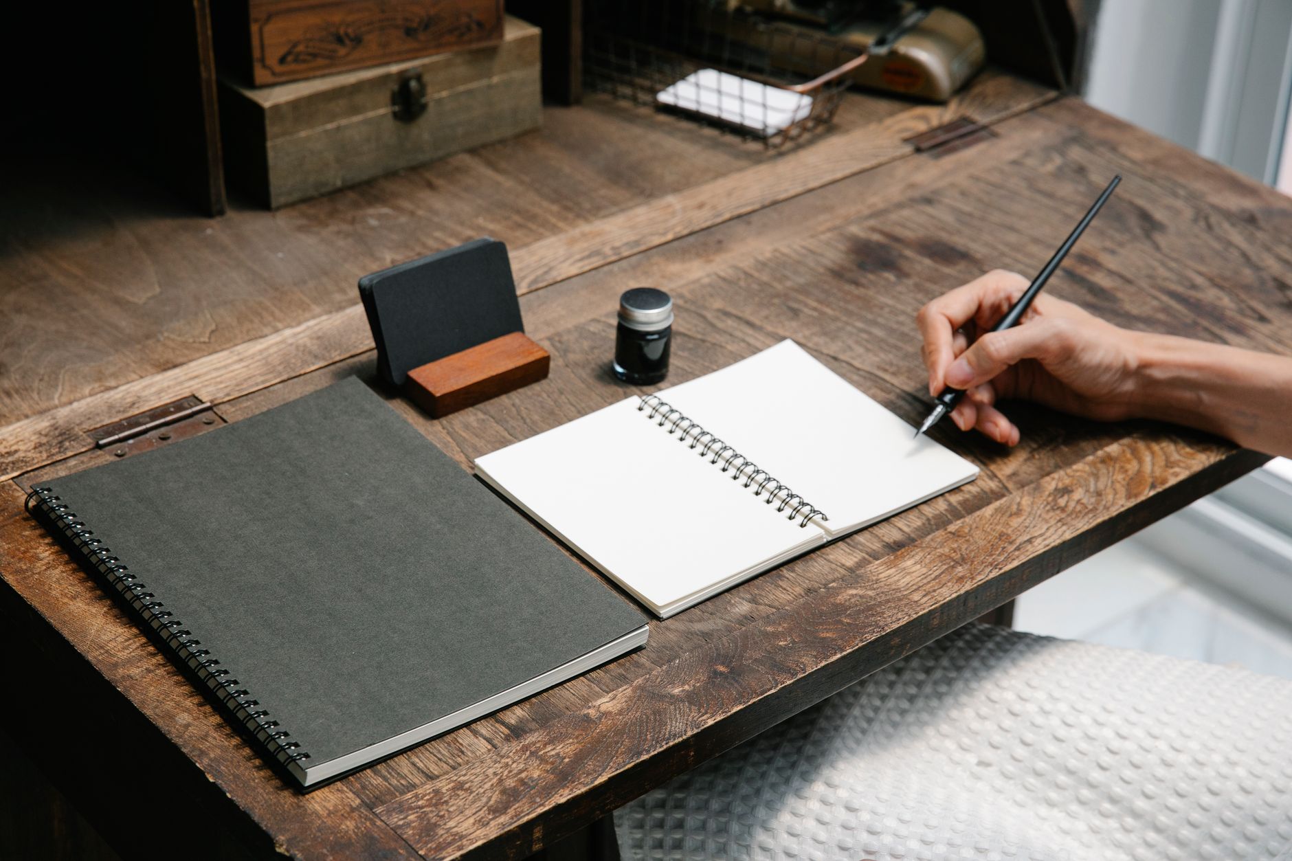 Travel writer documenting notes in scenic mountain cabin